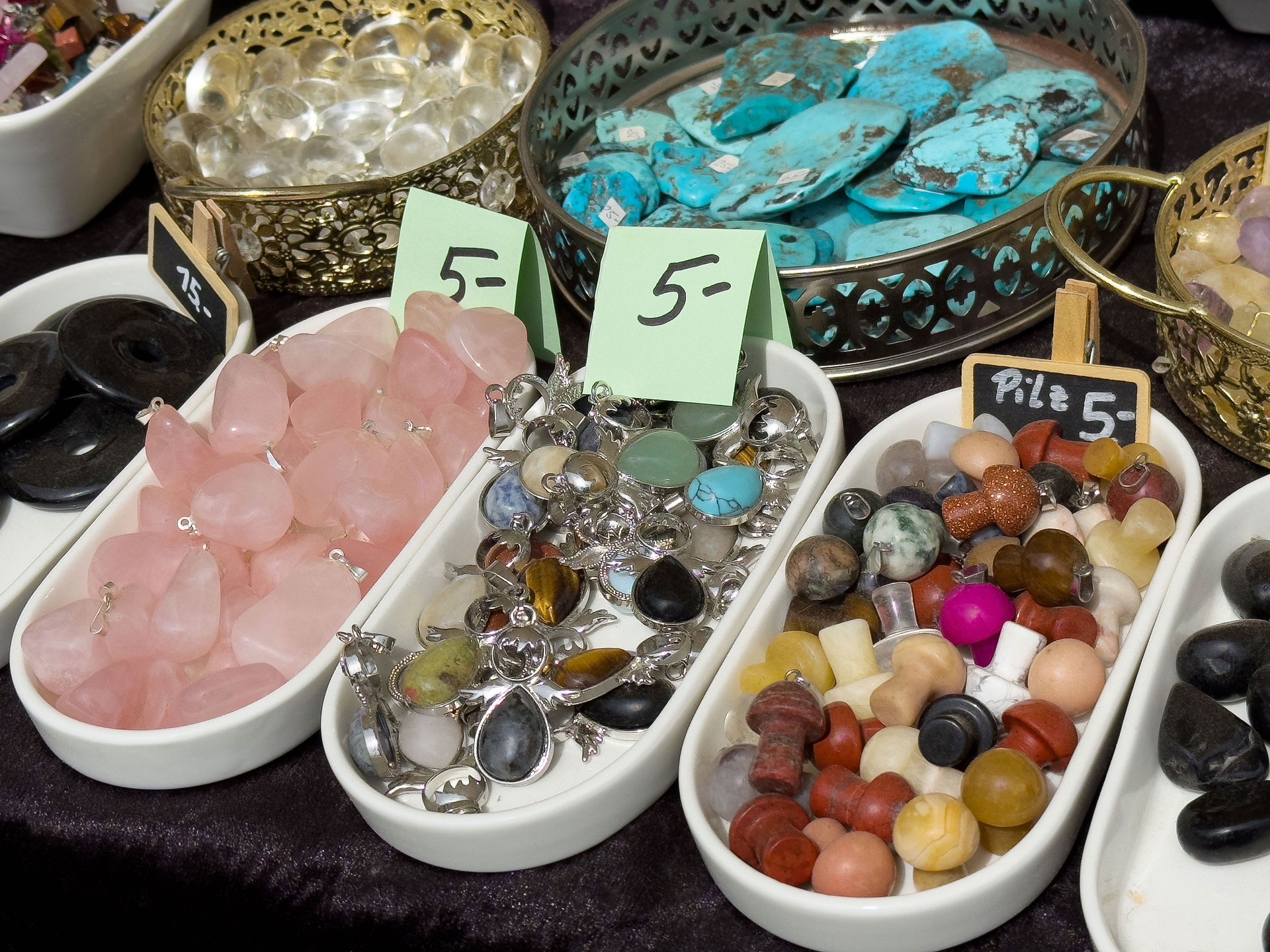Assortment of colorful gemstones and crystals on display at a jewelry market