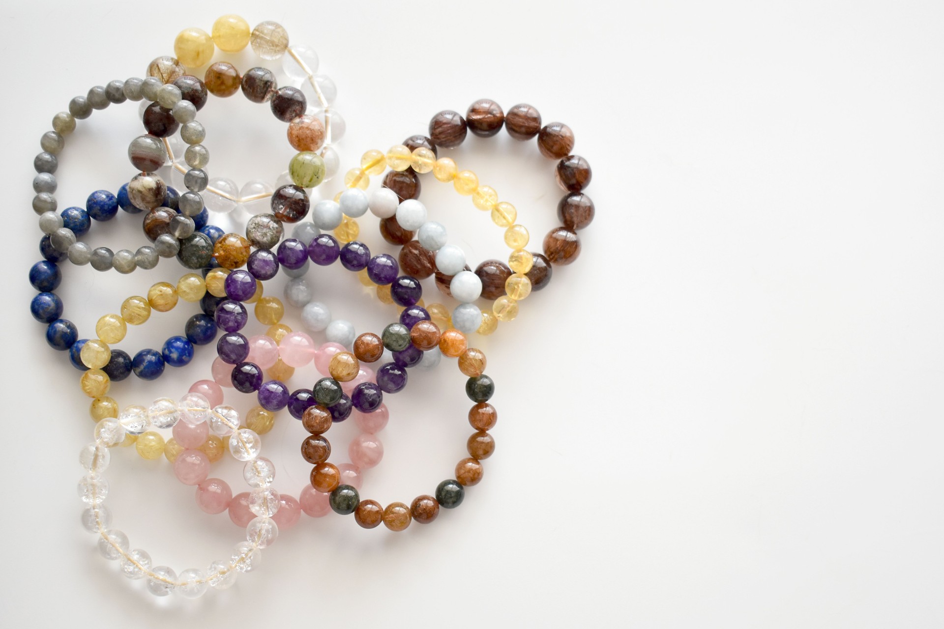 Collection of crystal gemstones bracelets.